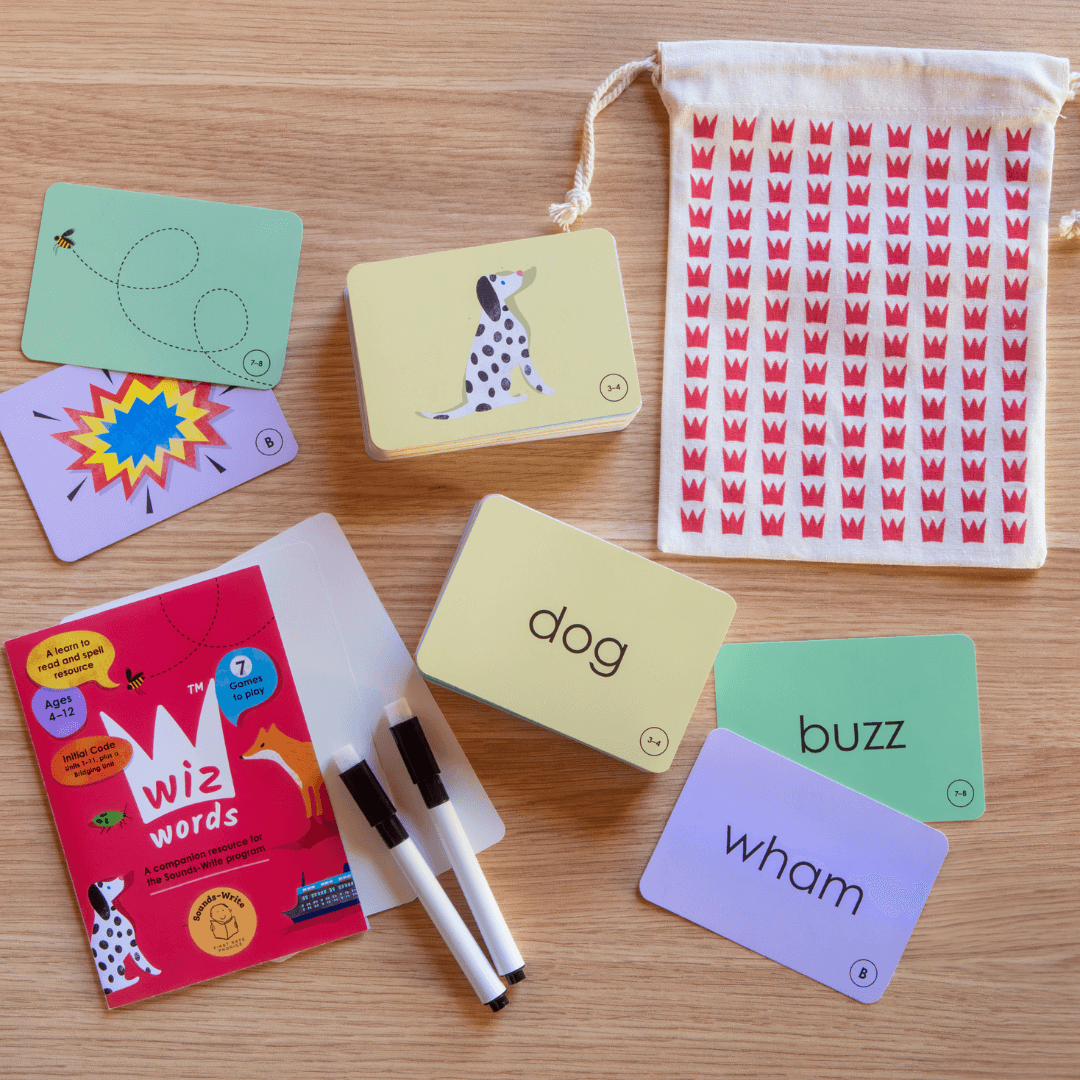 Wiz Words card game's contents including 164 Wiz Word Cards, 2 Write and Wipe Cards, 2 Marker Pens, and a Bonus Storage Bag.