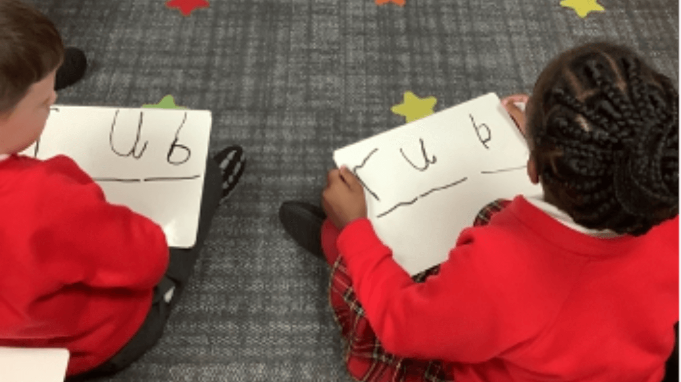 Children with whiteboards